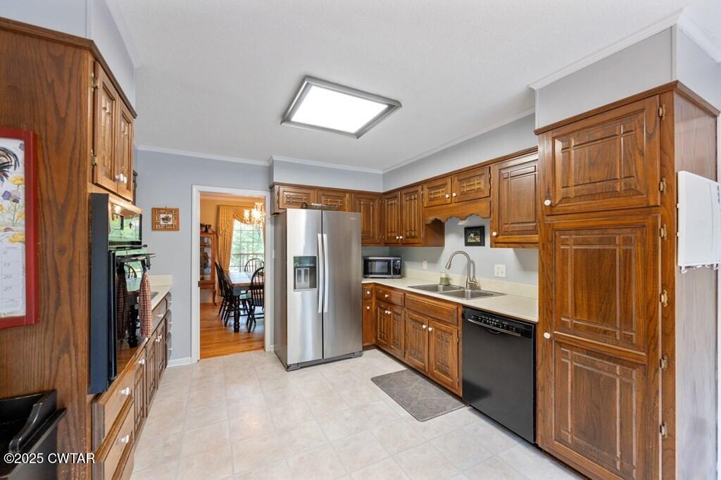255 Hartley Road Camden, TN 38320 - Photo 34 of 79 a kitchen with stainless steel appliances granite countertop a refrigerator and a sink