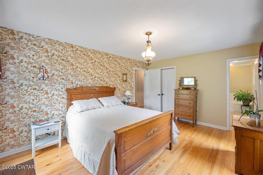 255 Hartley Road Camden, TN 38320 - Photo 38 of 79 a bedroom with a bed and wooden floor