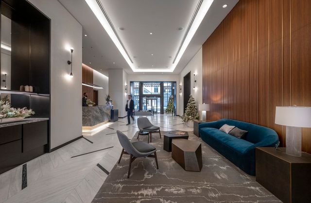 a living room with furniture and a lamp