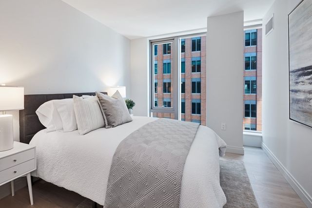 a bedroom with a bed and a book shelf