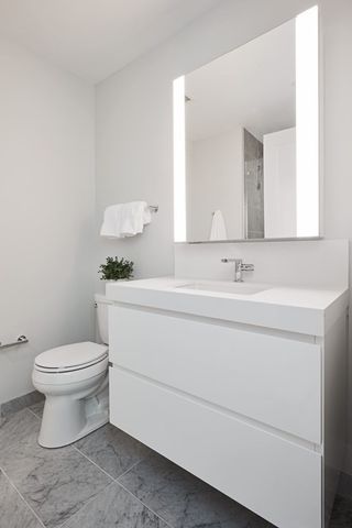 a bathroom with a sink toilet and mirror