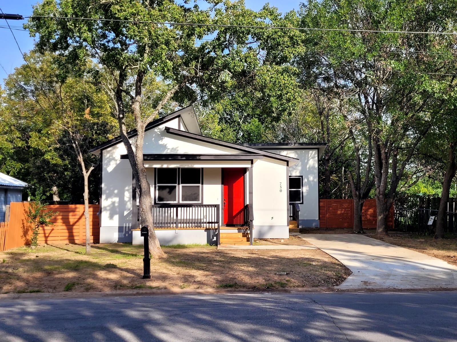 750 South Main Street Lockhart, TX 78644 - Photo 2 of 31 View of front of property featuring covered porch and view of scattered trees