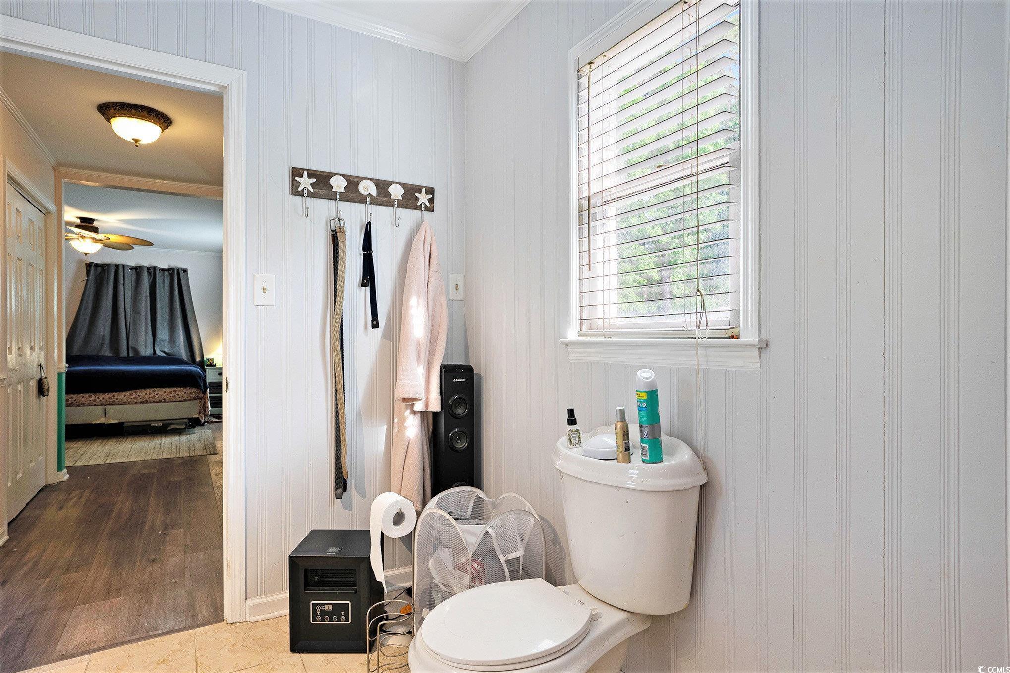 238 Robin Drive Georgetown, SC 29440 - Photo 16 of 31 Bathroom featuring a ceiling fan, toilet, and crown molding