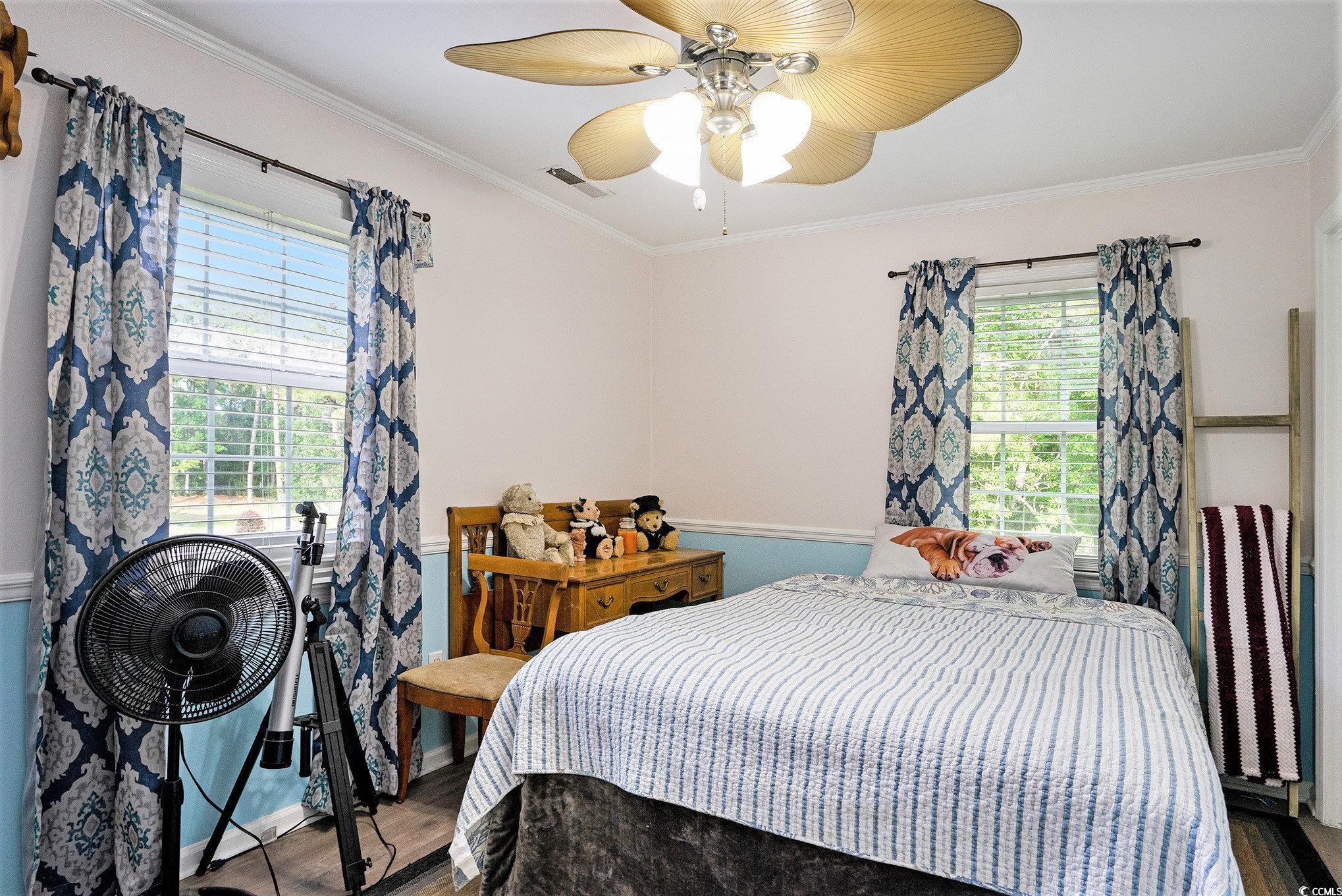 238 Robin Drive Georgetown, SC 29440 - Photo 22 of 31 Bedroom featuring multiple windows, wood finished floors, ornamental molding, and ceiling fan