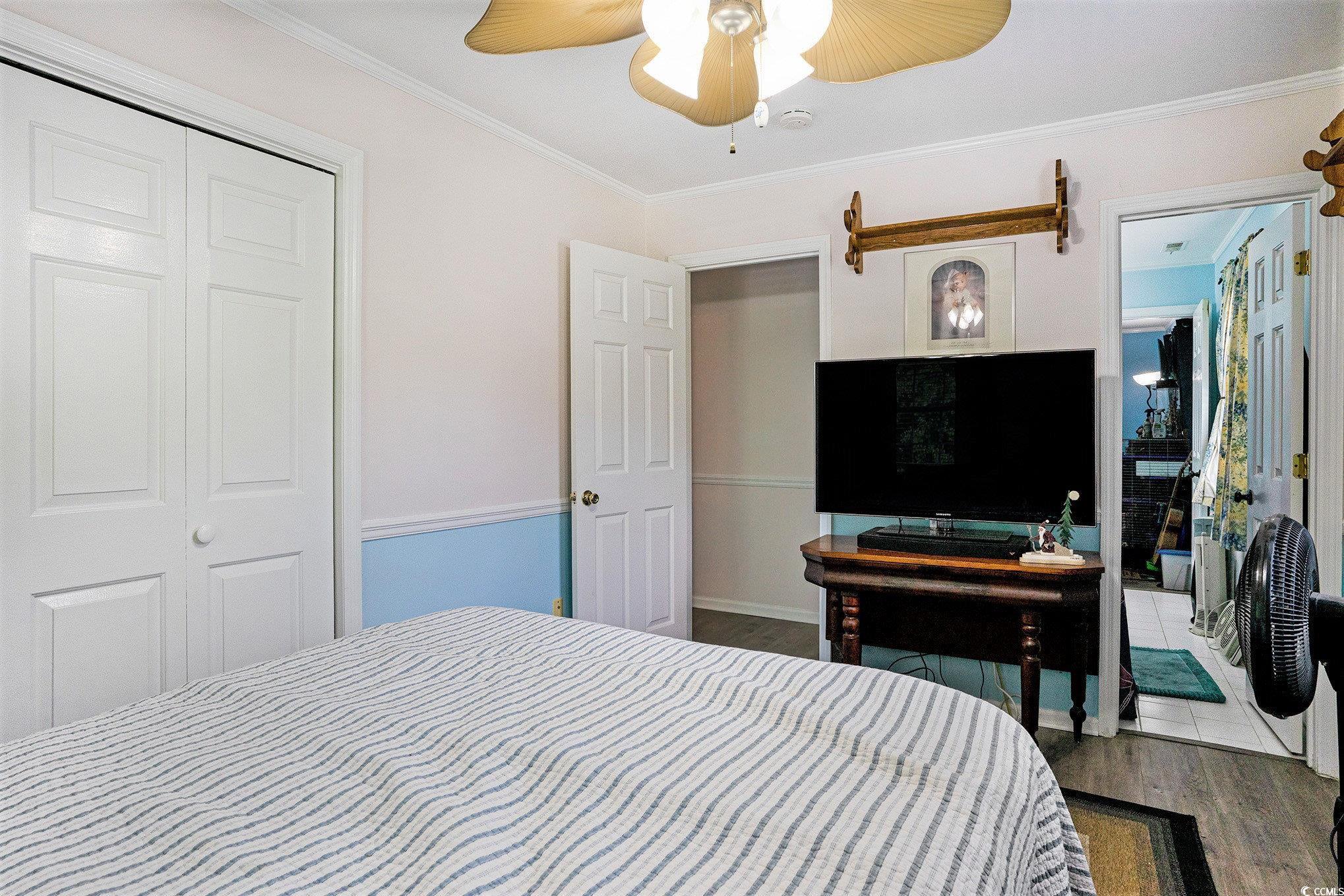 238 Robin Drive Georgetown, SC 29440 - Photo 23 of 31 Bedroom with wood finished floors, ornamental molding, a ceiling fan, a closet, and baseboards