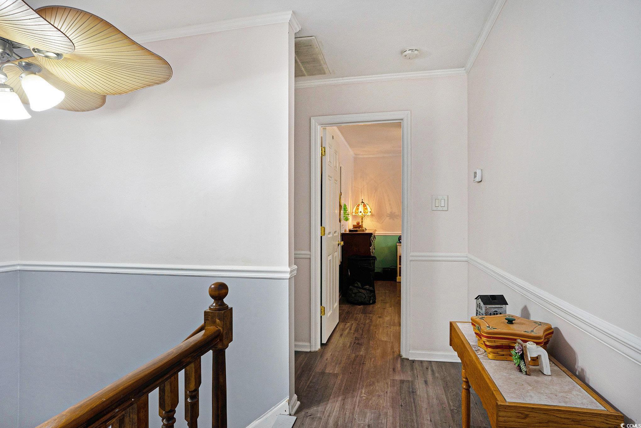 238 Robin Drive Georgetown, SC 29440 - Photo 26 of 31 Corridor featuring wood finished floors, ornamental molding, baseboards, and an upstairs landing