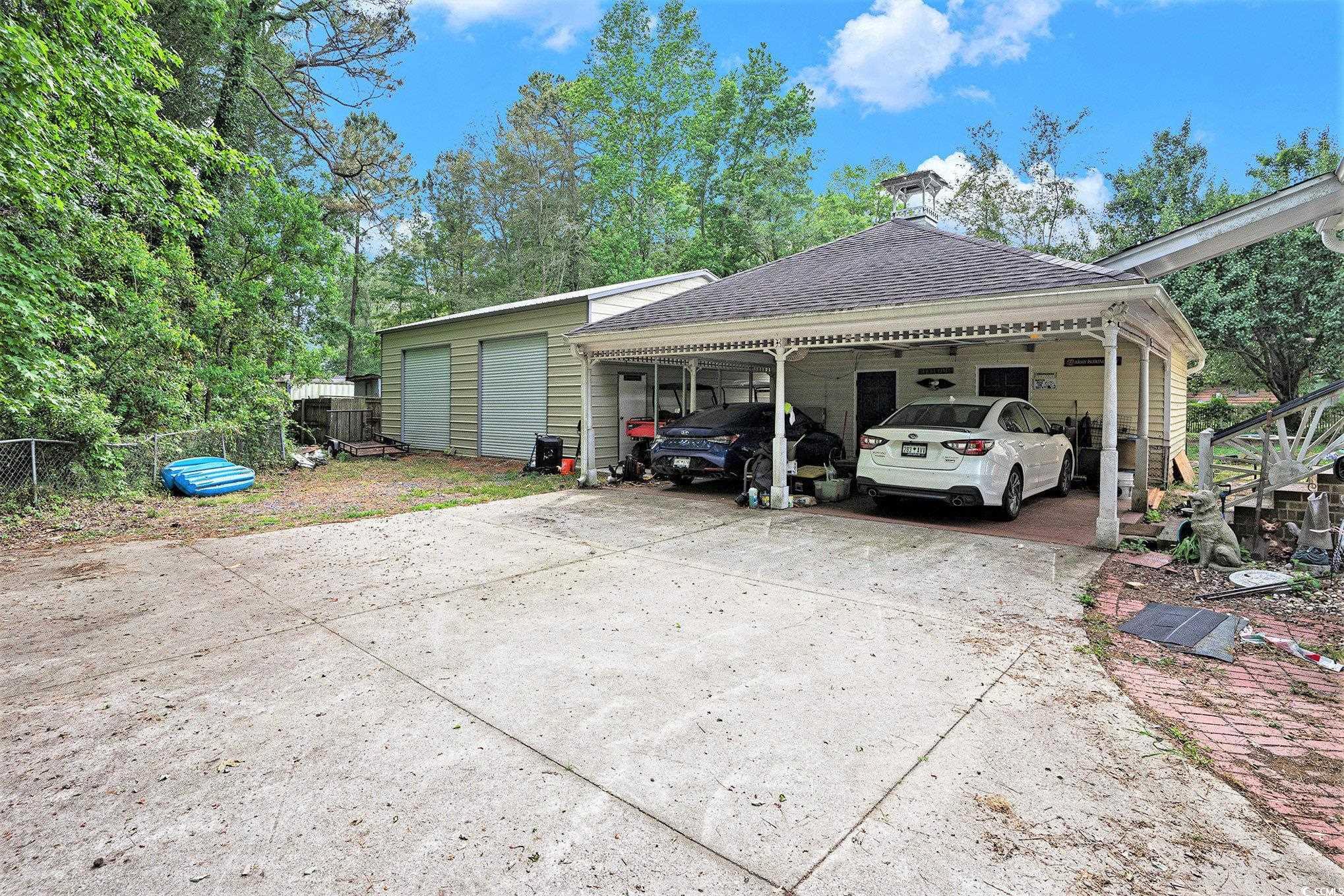 238 Robin Drive Georgetown, SC 29440 - Photo 29 of 31 View of vehicle parking featuring fence and a carport