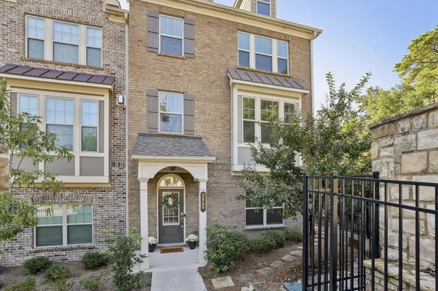 a front view of a brick house with large windows