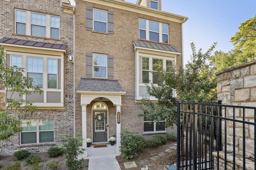 a front view of a brick house with large windows
