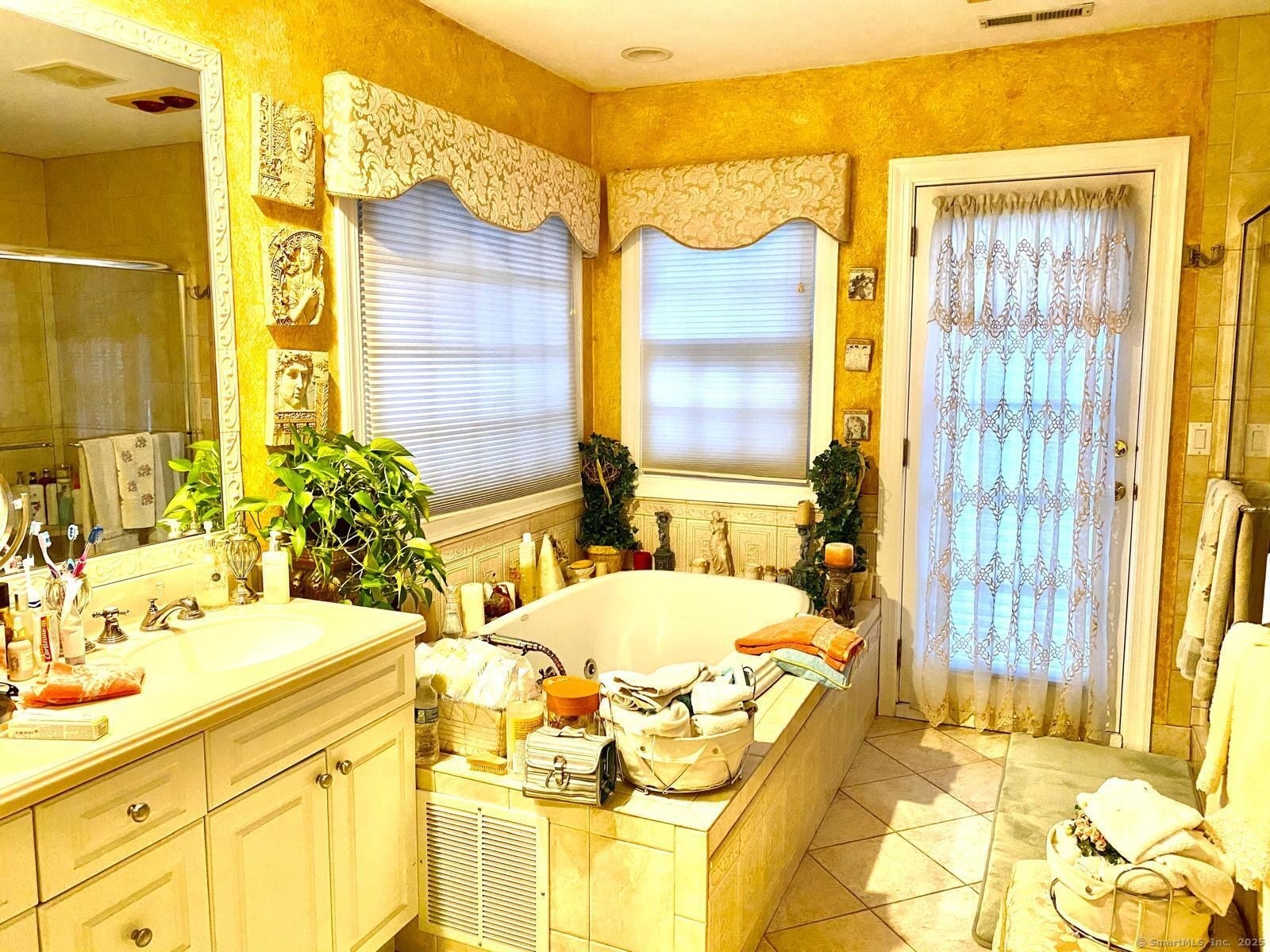 12 Old Mill Lane Stamford, CT 06902 - Photo 4 of 6 a bathroom with a tub sink and a mirror