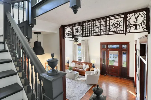 a living room with furniture or stairs and a wooden floor