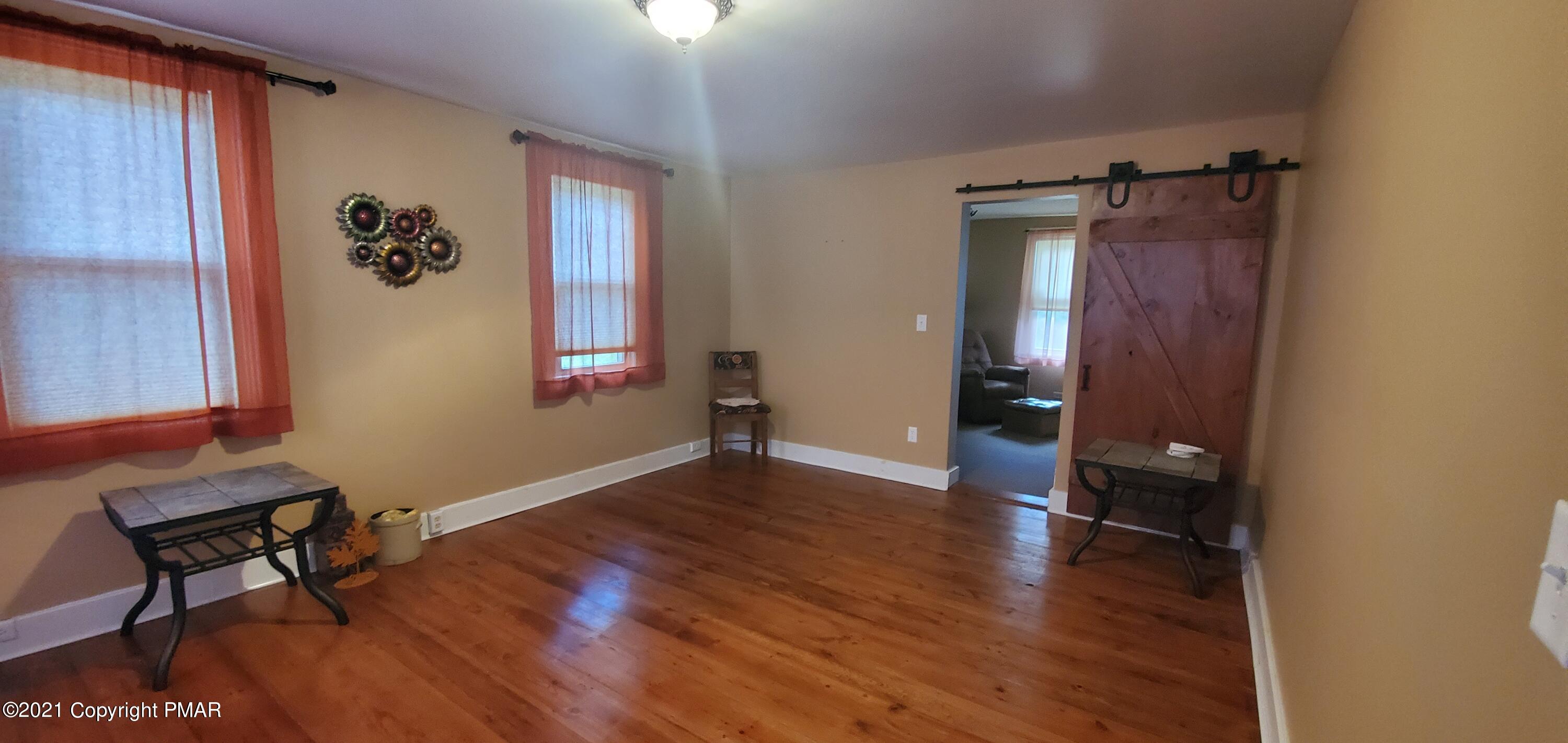 144 Merwinsburg Road Effort, PA 18330 - Photo 17 of 51 a view of a hallway with wooden floor and a window