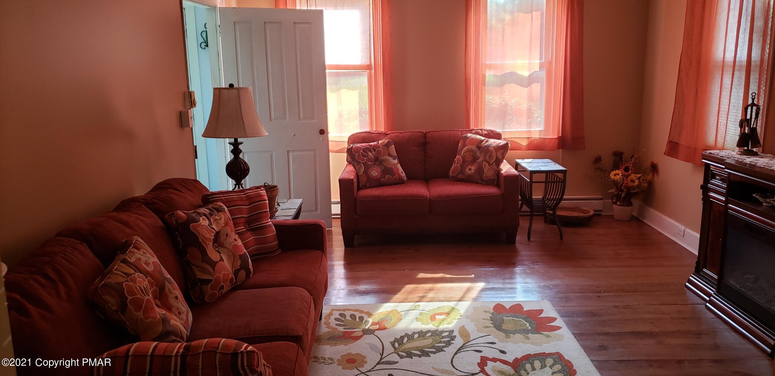 144 Merwinsburg Road Effort, PA 18330 - Photo 19 of 51 a living room with furniture fireplace and a large window