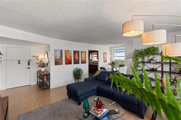 a living room with furniture and a potted plant