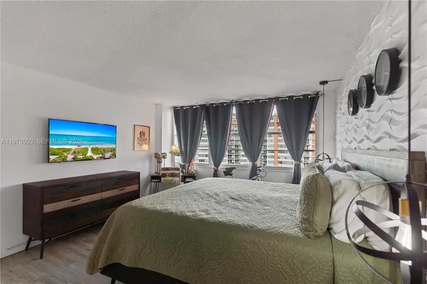 a bedroom with a bed and a flat screen tv