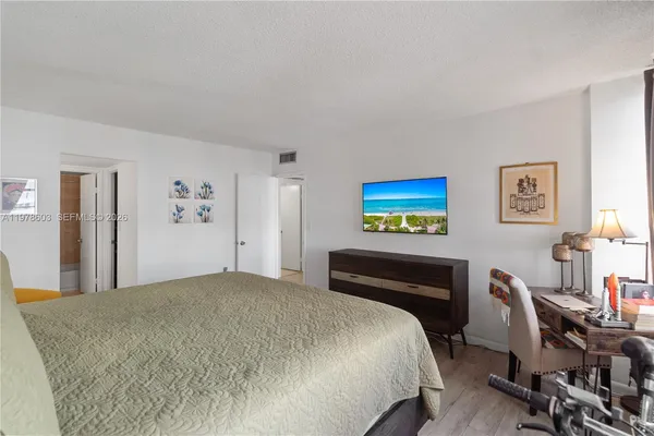 a bedroom with a bed and a desk