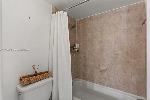 a bathroom with a shower a toilet and a sink