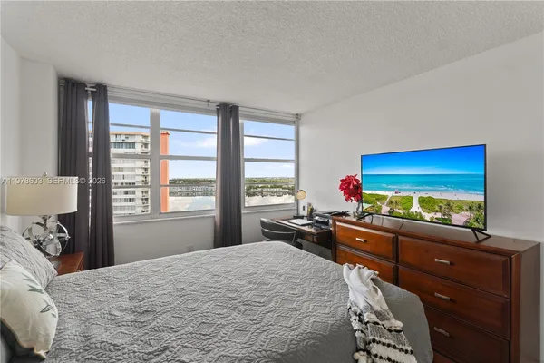 a bed room with a bed and a television