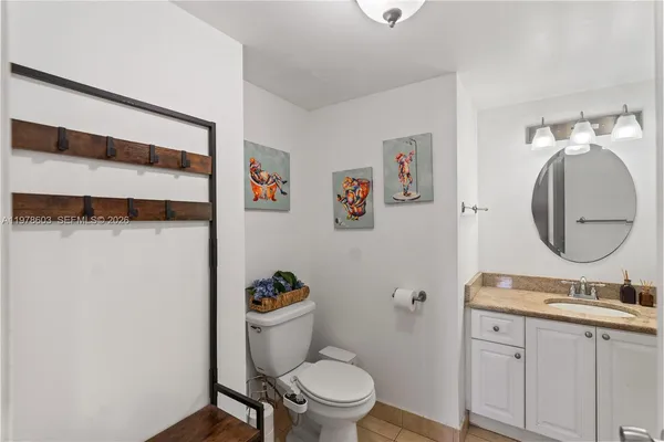 a bathroom with a toilet a sink and a mirror