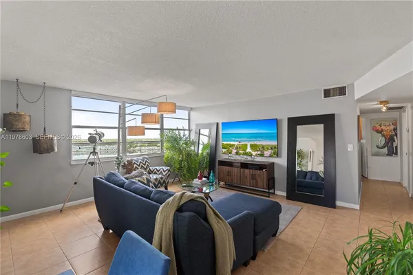 a living room with furniture fireplace and window