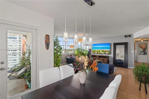 a living room with furniture a rug and a floor to ceiling window