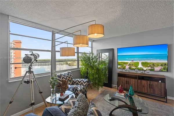 a living room with furniture and a large window