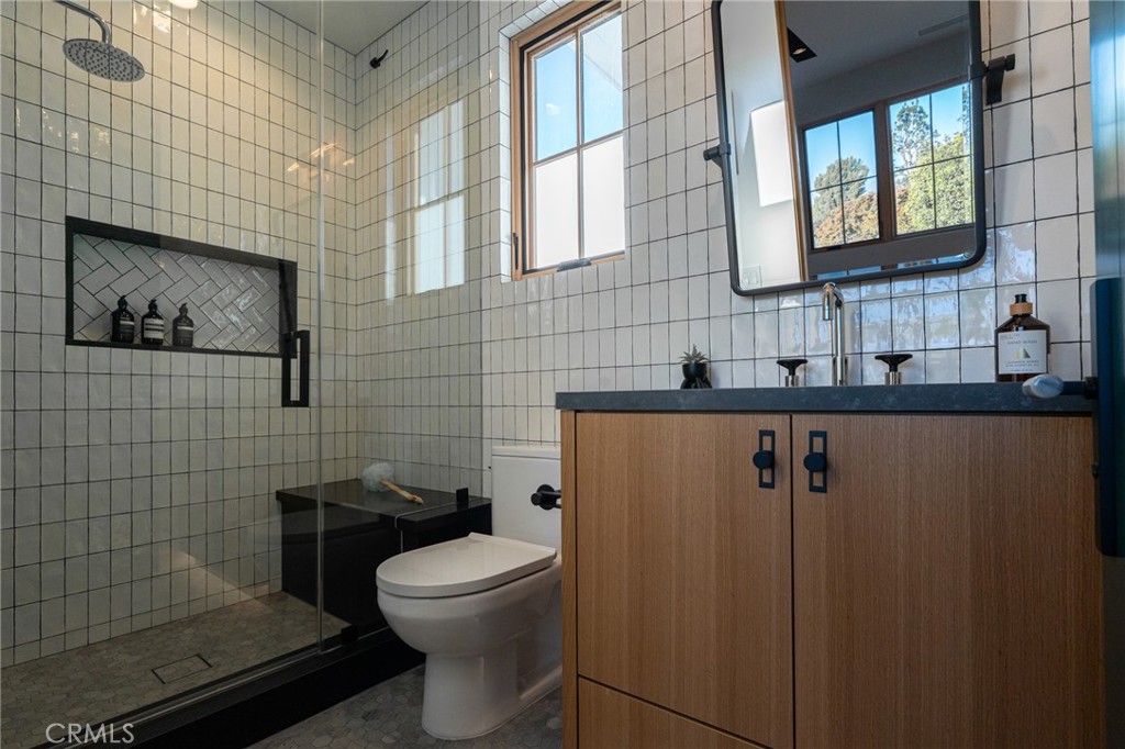 5131 Strohm Avenue Toluca Lake, CA 91601 - Photo 49 of 67 a bathroom with a toilet sink and shower