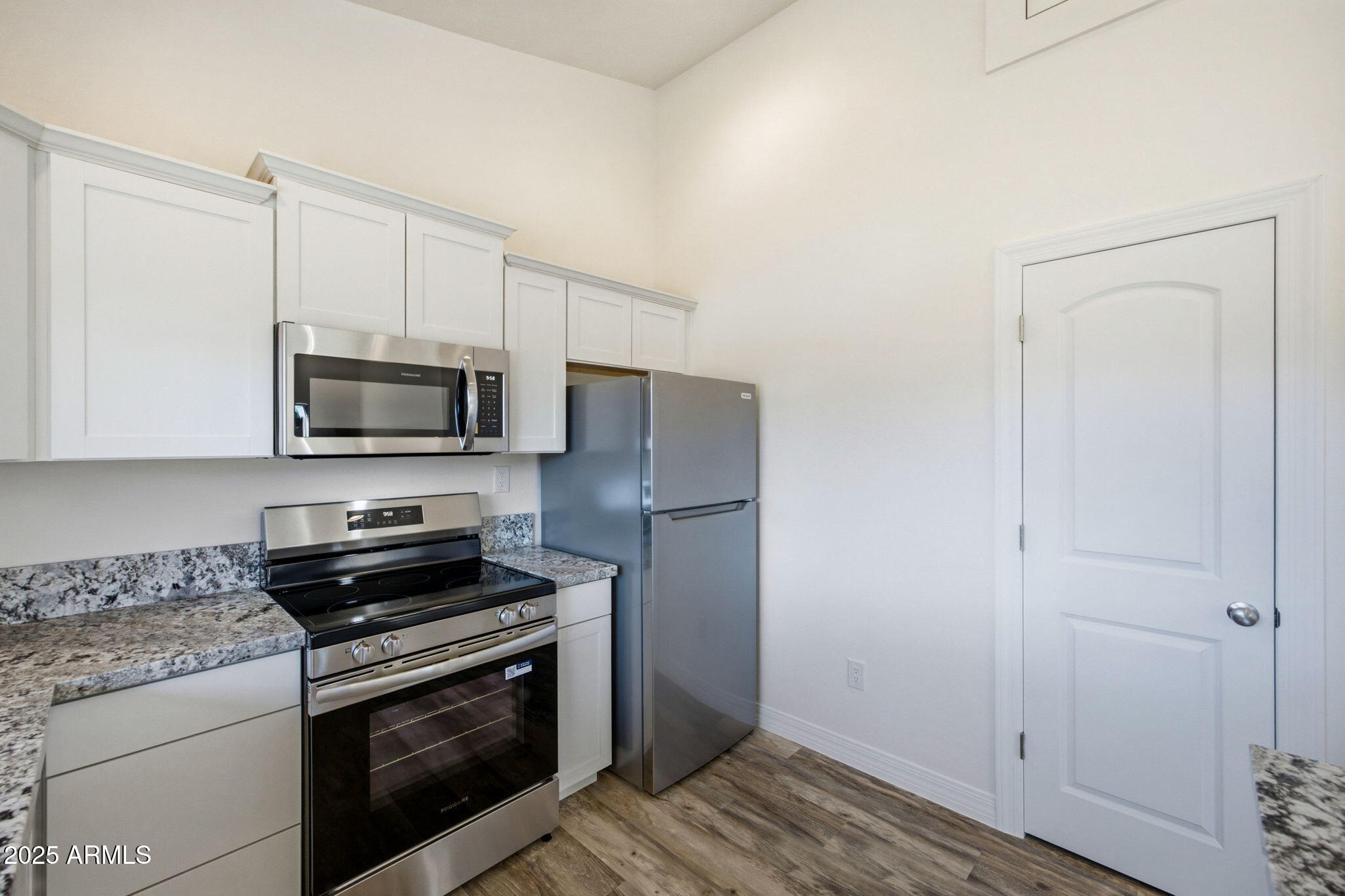 2224 Meadow Lane Overgaard, AZ 85933 - Photo 11 of 30 a kitchen with stainless steel appliances white cabinets and a stove top oven