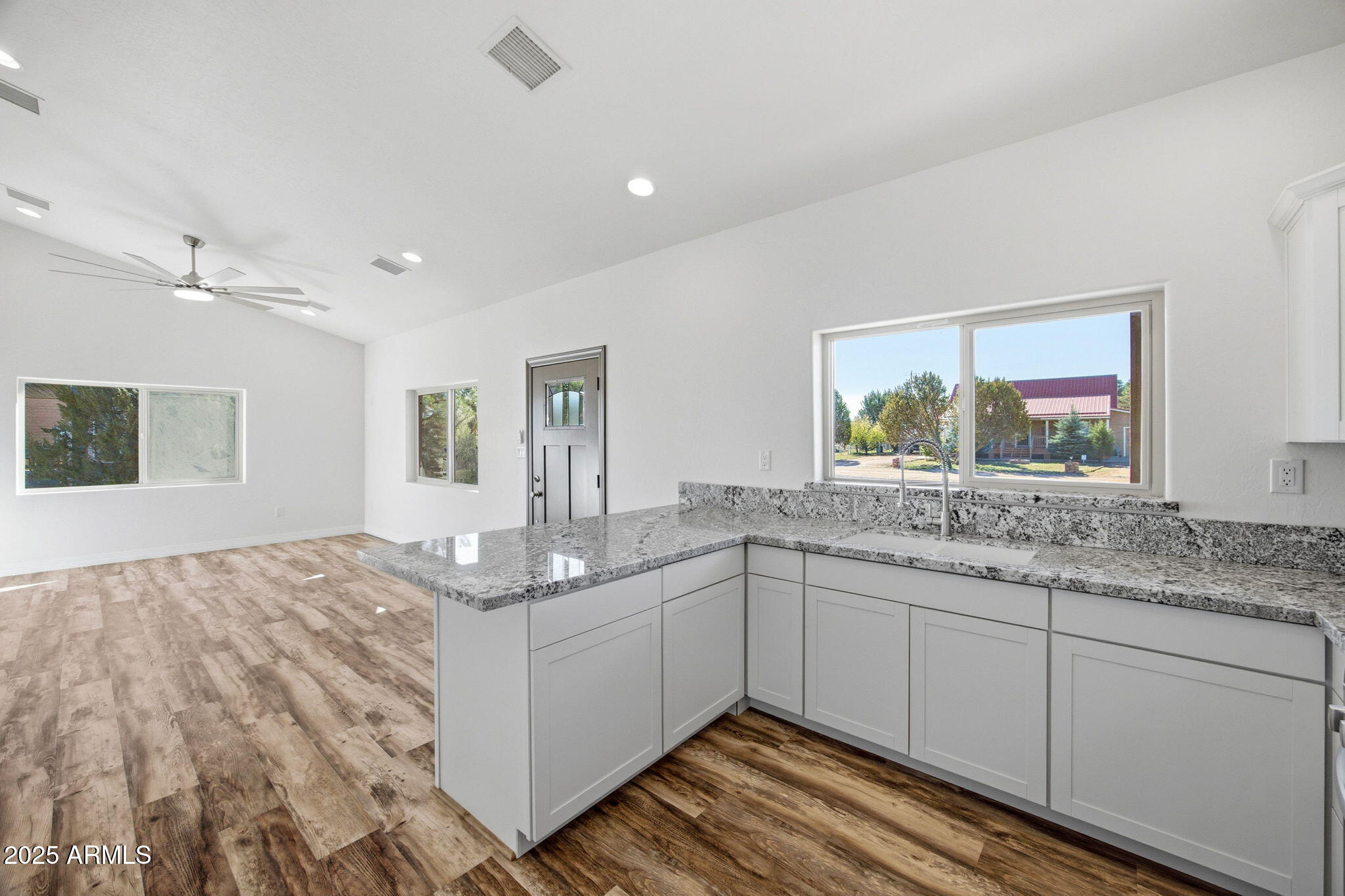 2224 Meadow Lane Overgaard, AZ 85933 - Photo 12 of 30 a bathroom with a granite countertop sink and a window