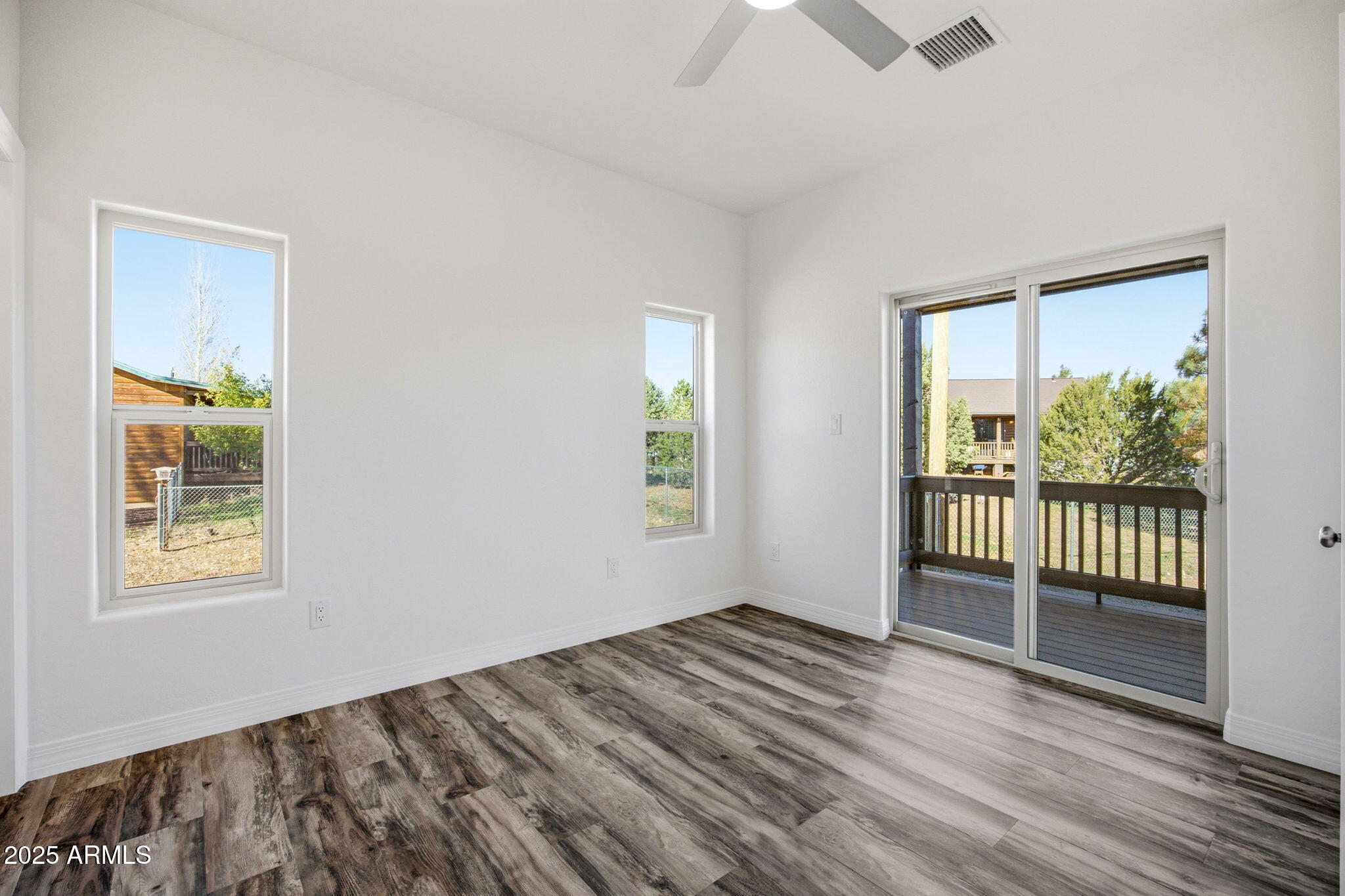 2224 Meadow Lane Overgaard, AZ 85933 - Photo 13 of 30 a view of a room with wooden floor and windows