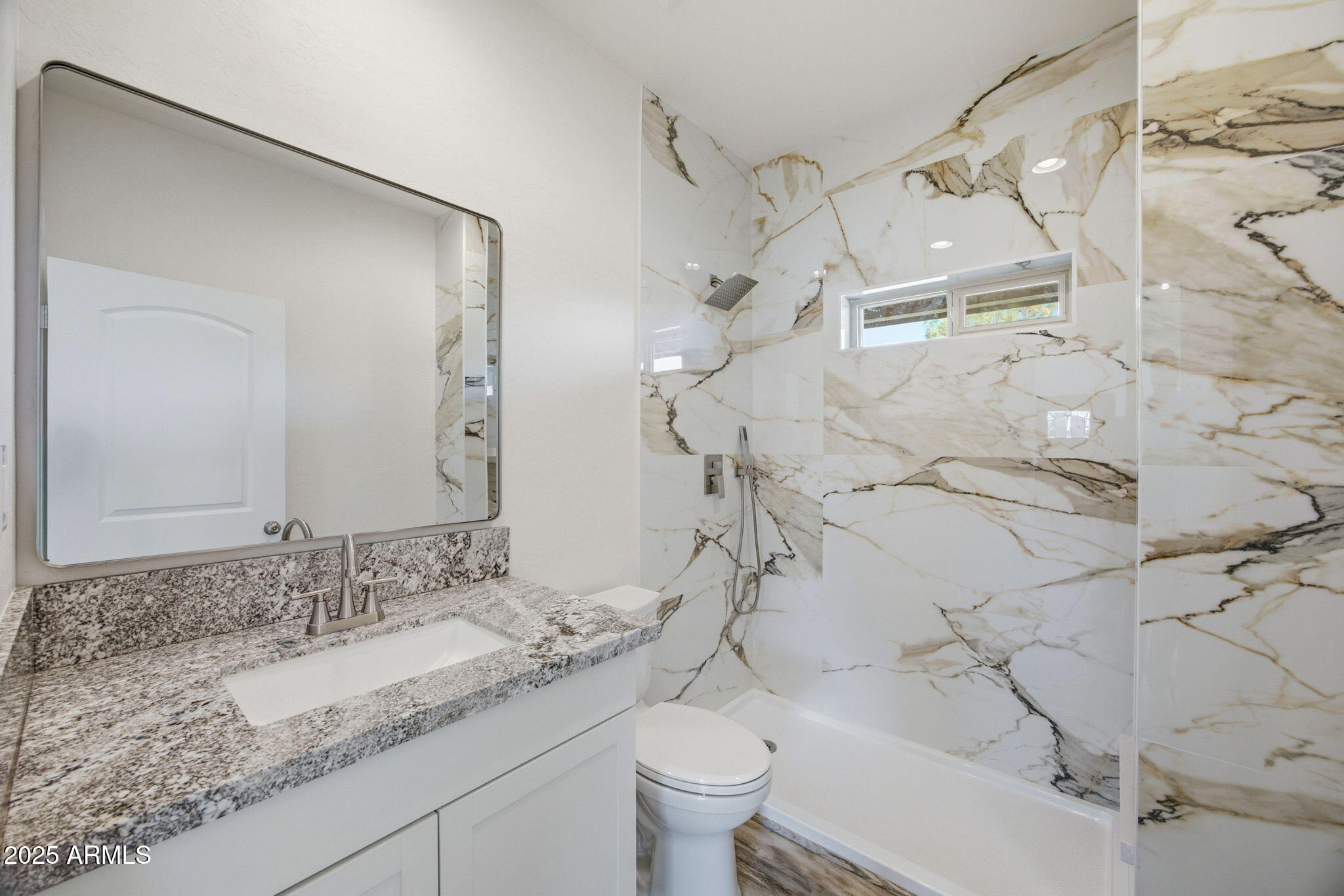 2224 Meadow Lane Overgaard, AZ 85933 - Photo 20 of 30 a bathroom with a granite countertop sink a toilet and a mirror