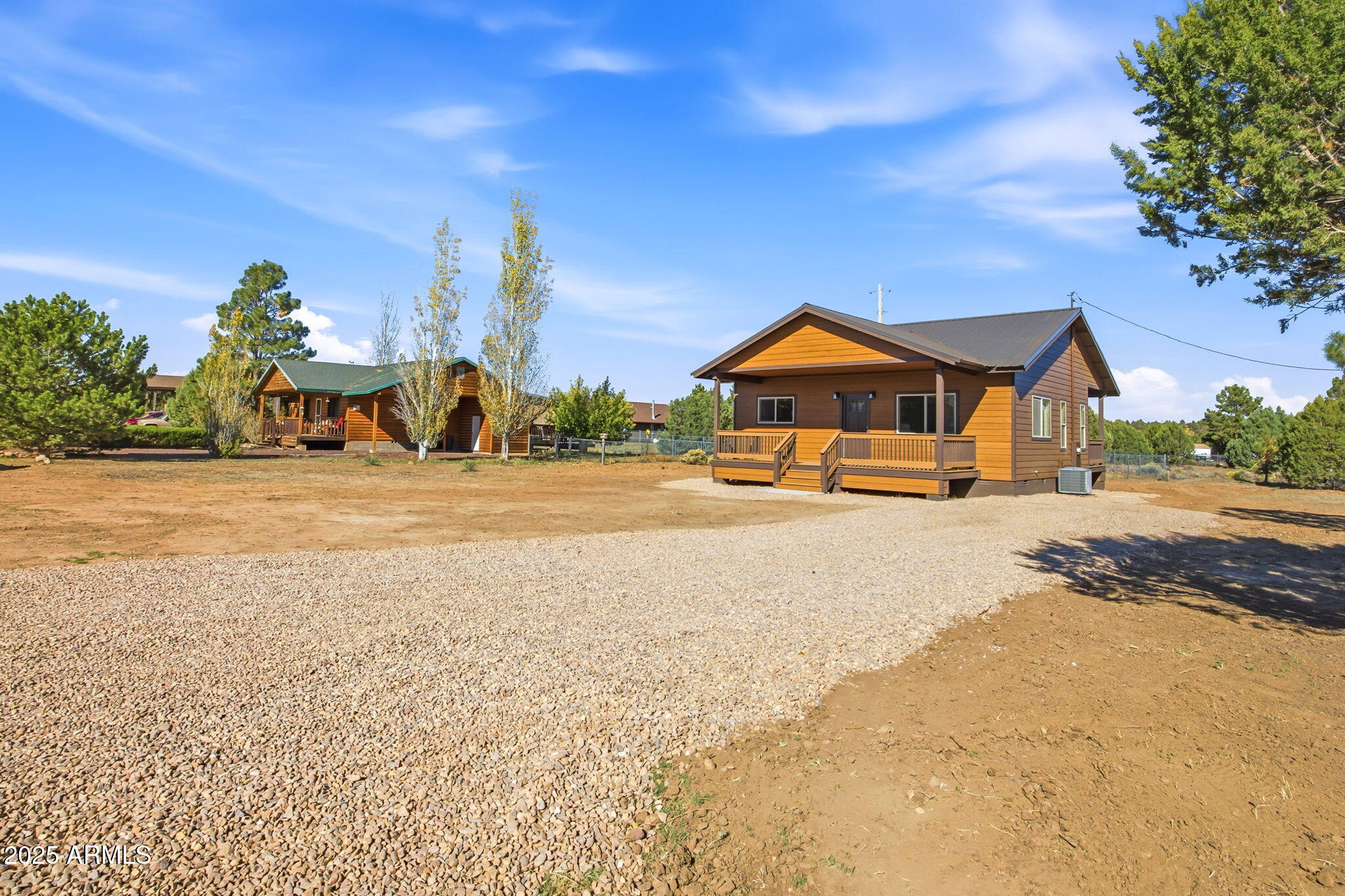 2224 Meadow Lane Overgaard, AZ 85933 - Photo 2 of 30 a front view of a house with a yard and garage
