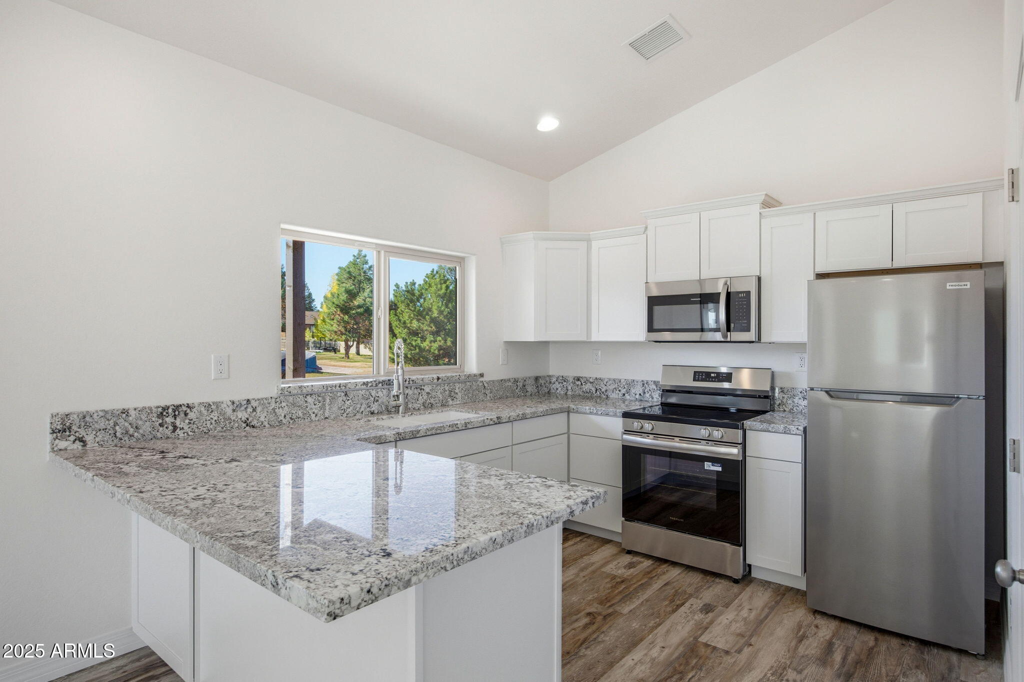 2224 Meadow Lane Overgaard, AZ 85933 - Photo 10 of 30 a kitchen with stainless steel appliances granite countertop a sink stove and refrigerator