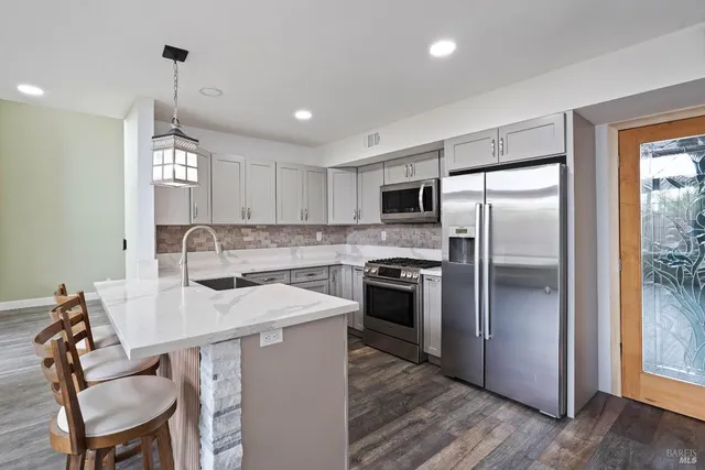 a kitchen with a sink stove and refrigerator