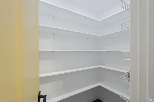 a view of a hallway with wooden floor and entryway