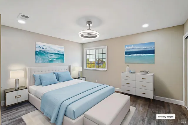 a bedroom with a large bed and a chandelier