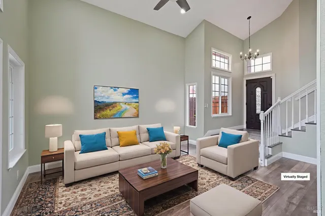 a living room with furniture and a chandelier