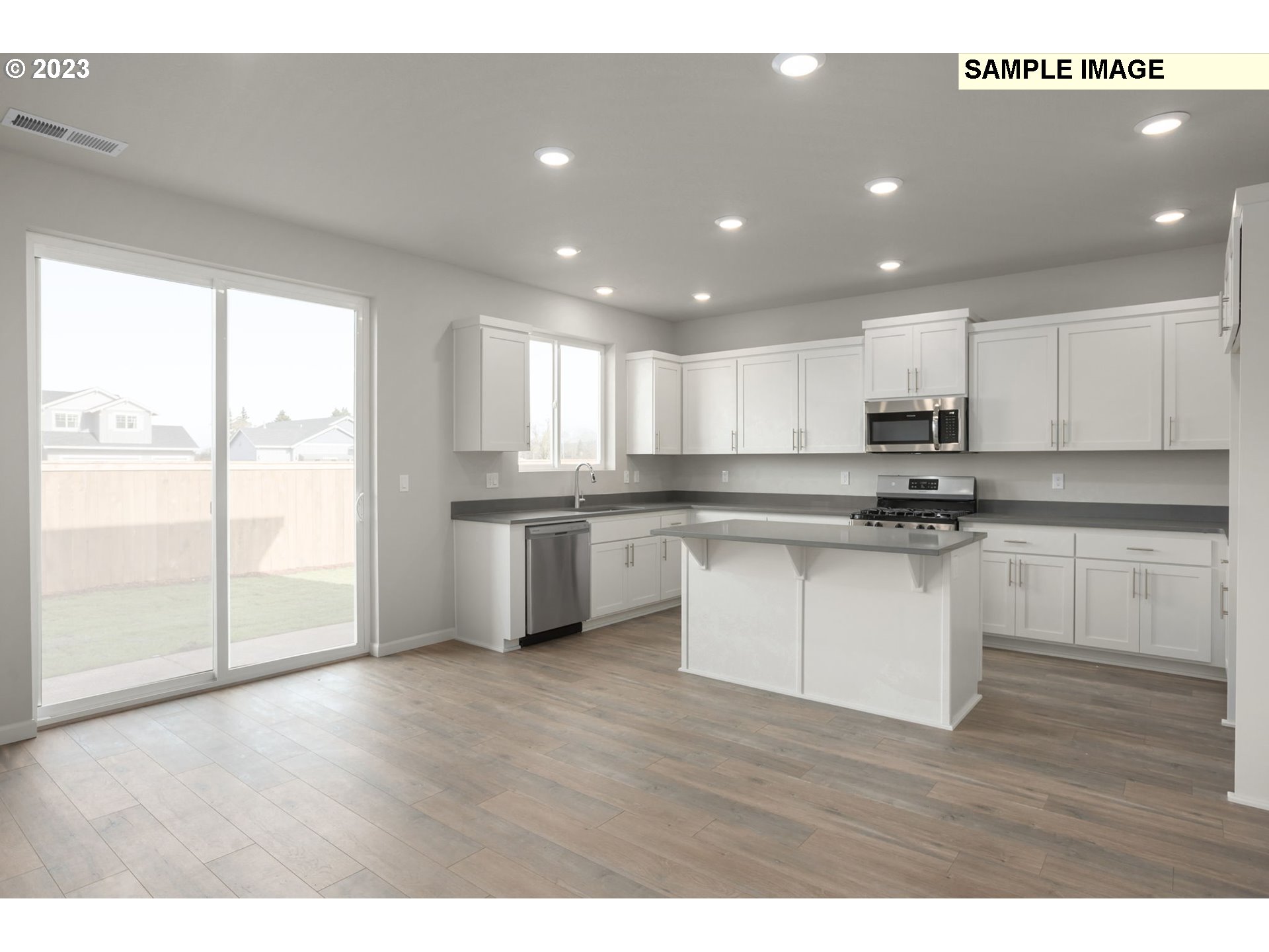 6162 Southeast 22nd Street Gresham, OR 97080 - Photo 3 of 17 a kitchen with stainless steel appliances granite countertop a stove a sink and a refrigerator