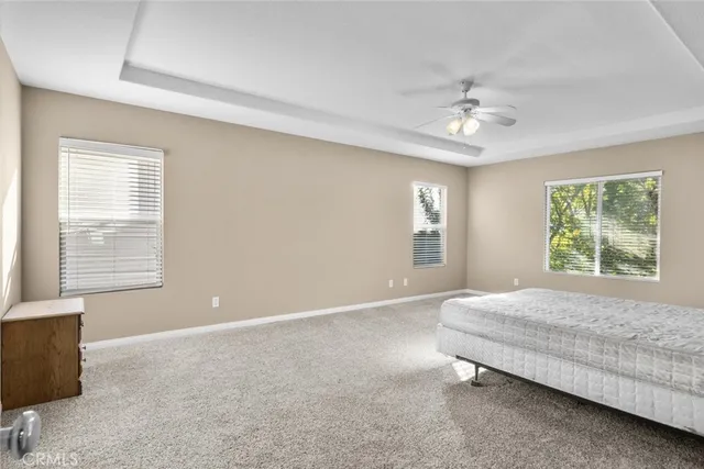 a spacious bedroom with a bed and a window