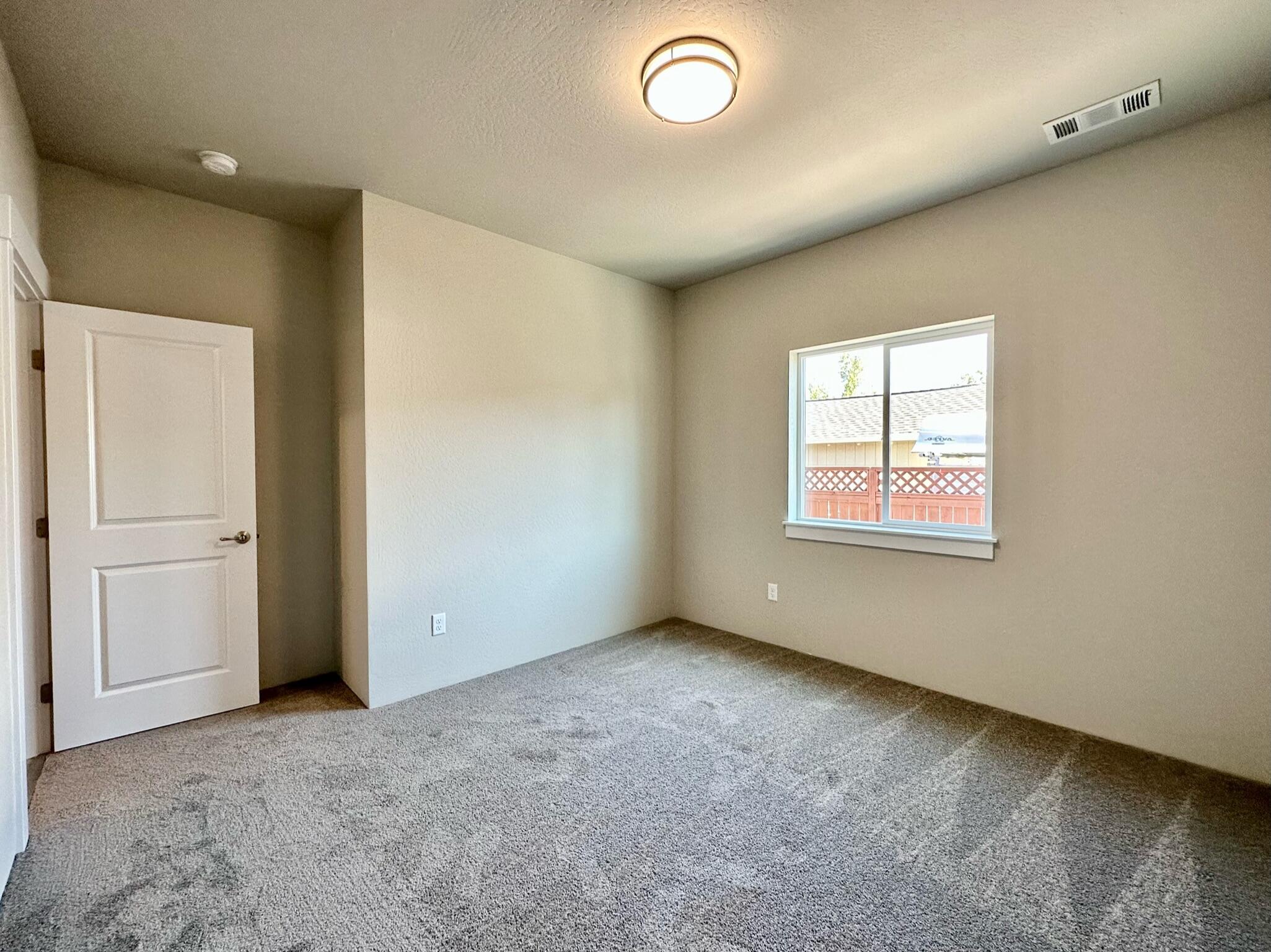 281 Autumn Ridge Road Talent, OR 97540 - Photo 14 of 39 an empty room with windows