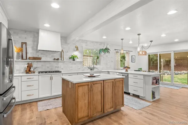 a kitchen with white cabinets and white appliances