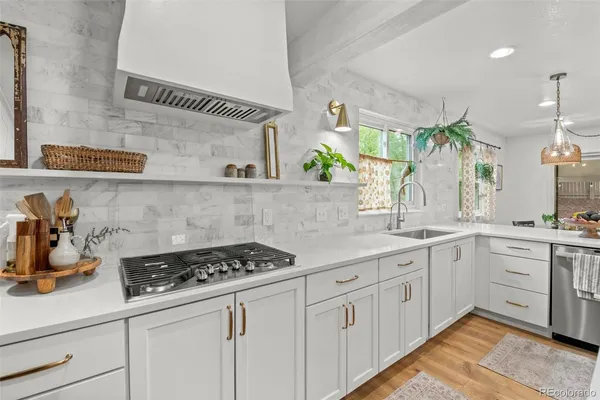 a kitchen with white cabinets and a stove