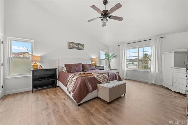 a spacious bedroom with a bed a couch and a window