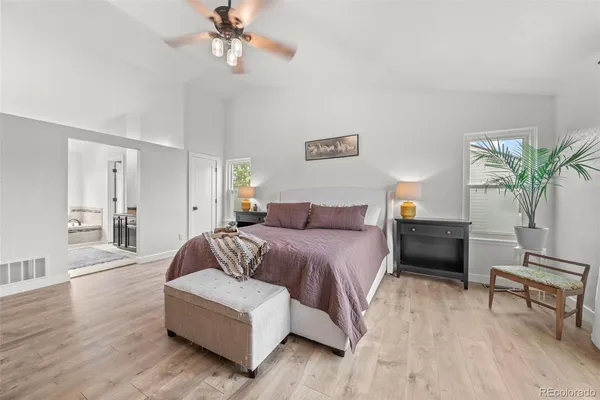 a spacious bedroom with a bed and a couch