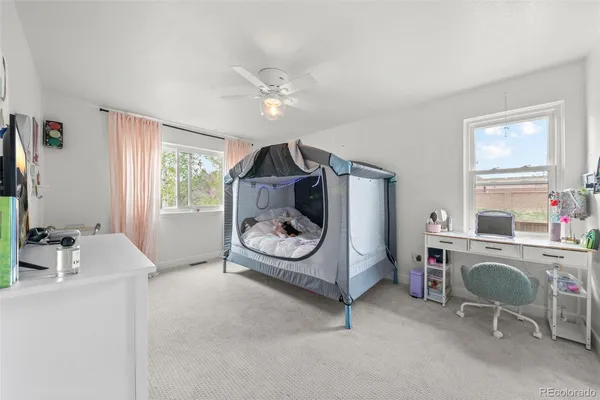 a bedroom with furniture and a window