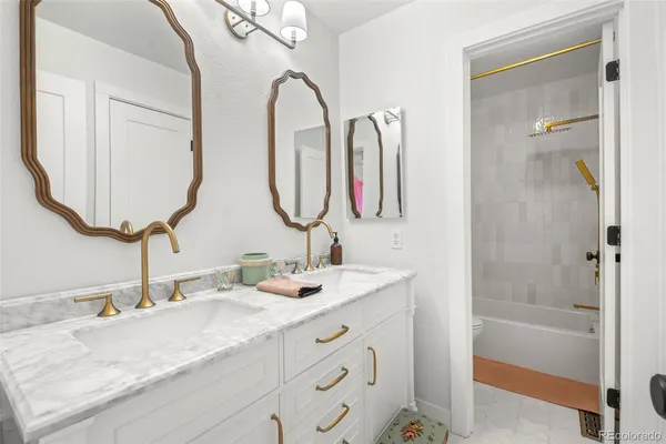 a bathroom with a double vanity sink and a mirror