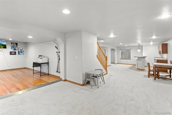 a view of a livingroom with furniture and stairs