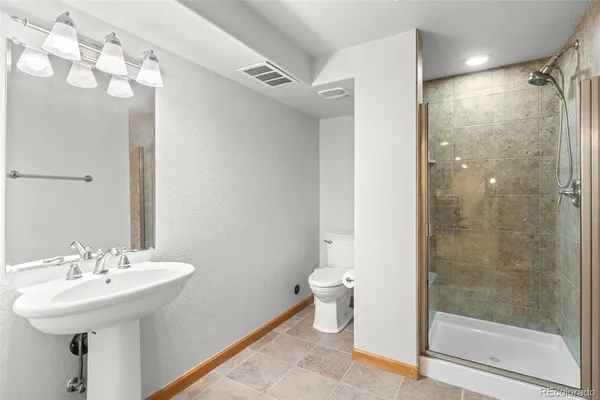 a bathroom with a sink toilet and shower