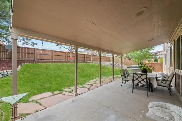 a view of a backyard with a large tree
