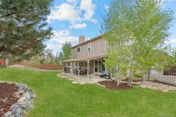 a backyard of a house with a garden and patio